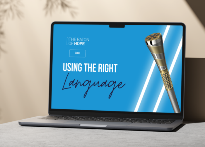 A mocked up image of a laptop on a grey surface in front of a neutral background with a Language Guide on the screen.